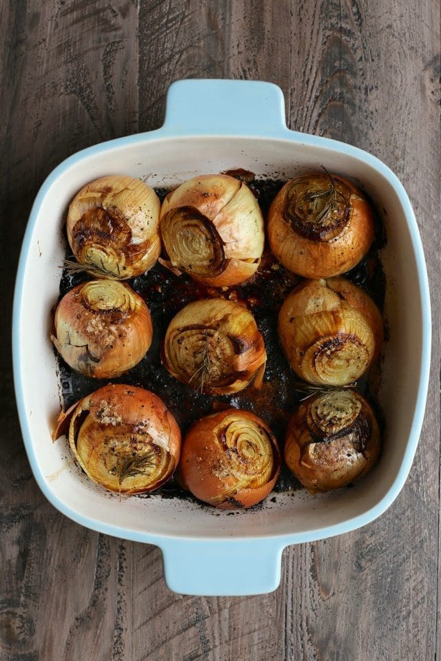 whole roasted onions in a baking dish
