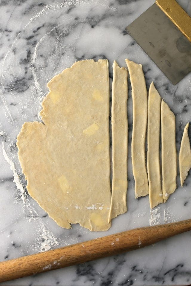 cutting dough into long strips