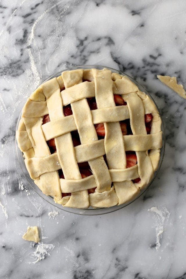 adding pie lattice crust to strawberry pie