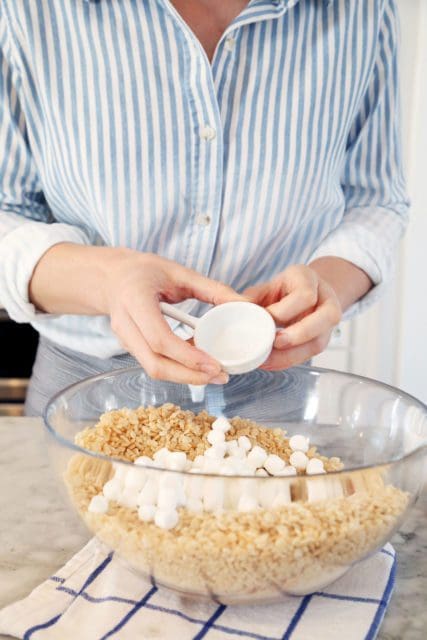 Adding sea salt to bowl of rice krispies treats