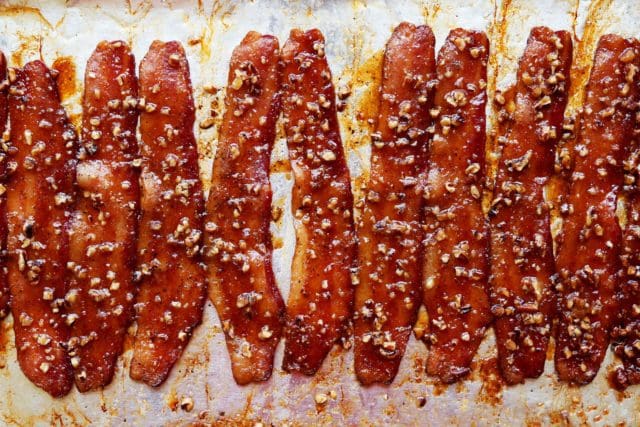 Baked praline bacon on a pan
