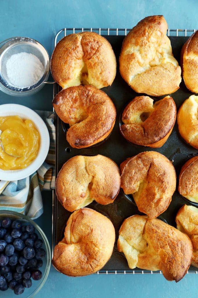 Golden brown baked Christmas Morning Popovers in the muffin pan.