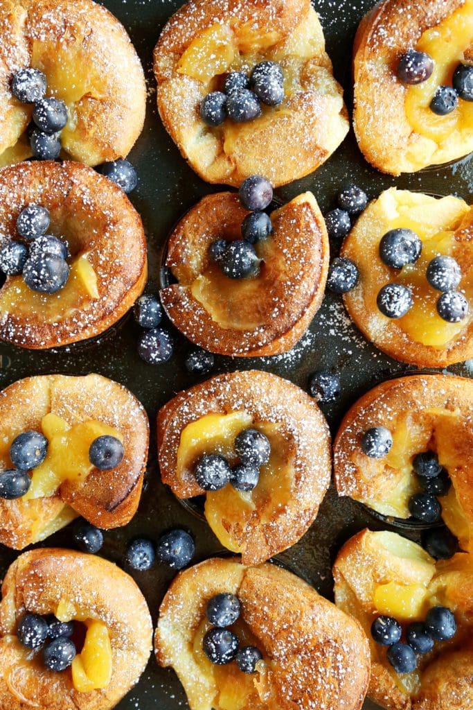 Overhead baked popovers with lemon curd and blueberries