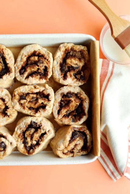 Sliced cinnamon rolls in a pan to be baked.