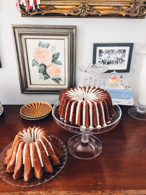 two small bundt cakes, glazed, sitting on counter