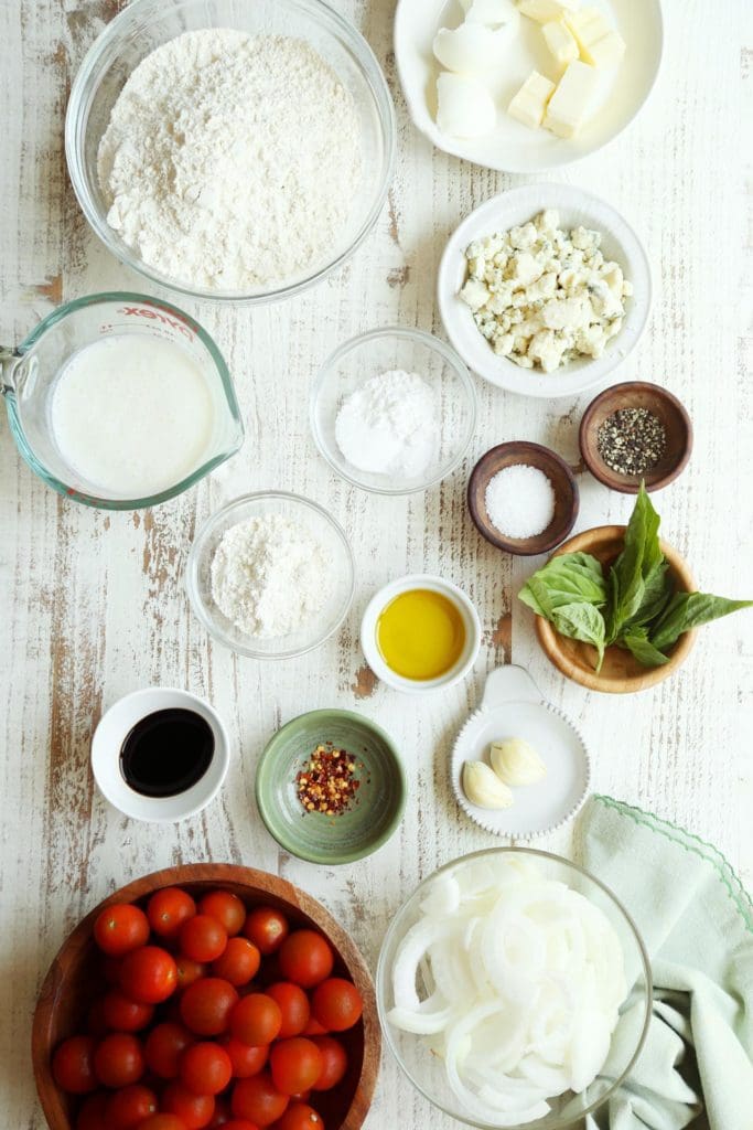 Ingredients for tomato pie in small bowls.