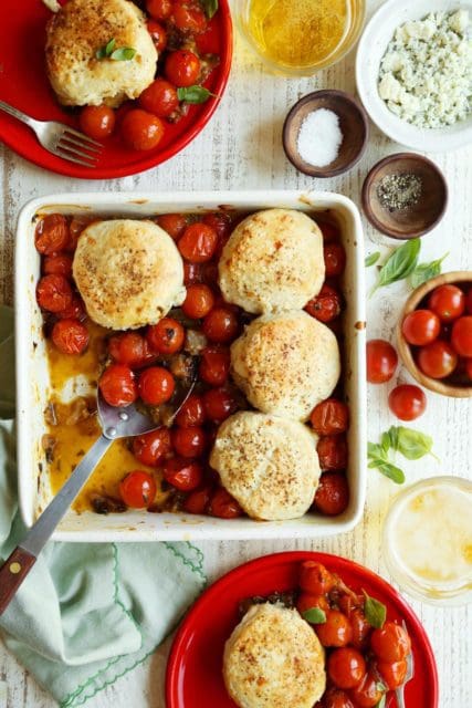 Tomato cobbler baked in a square baking dish.