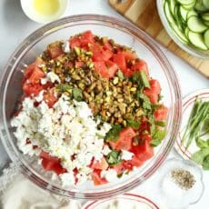 All ingredients for an easy watermelon salad in a large bowl.