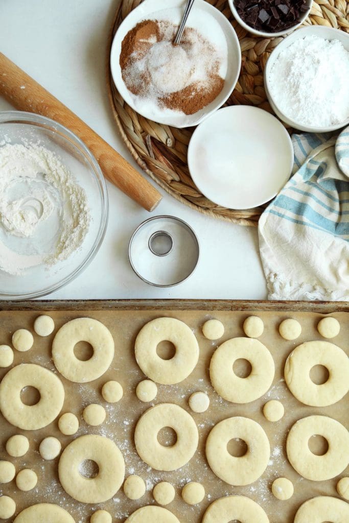 Classic yeast doughnut recipe cut into doughnut shapes and holes.