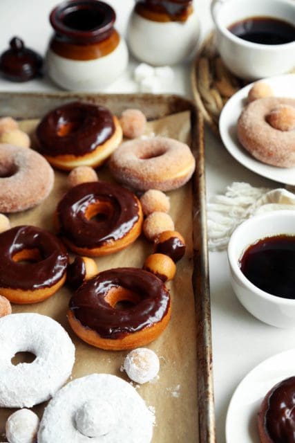 Classic yeast doughnut recipe glazed and sugared on a baking sheet.