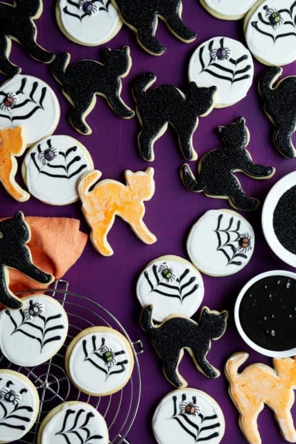 Halloween sugar cookie recipe frosted like black cats and spider webs.