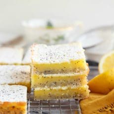 Stack of the perfect lemon bars recipe sliced and cooling on a wire rack.