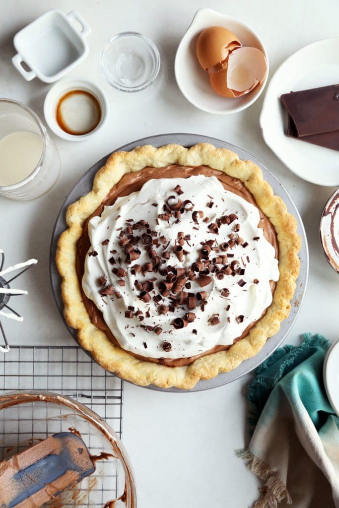 French silk pie topped with whipped cream and chocolate shavings.