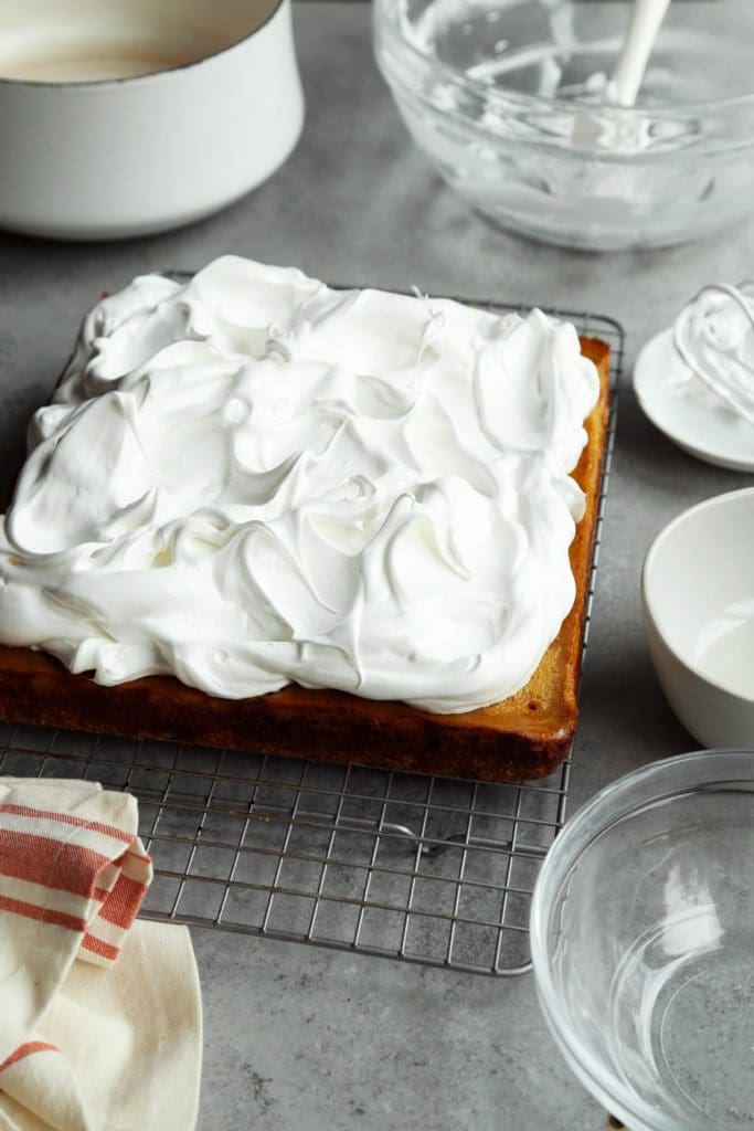 Fluffy meringue on top of baked pumpkin pie bars.