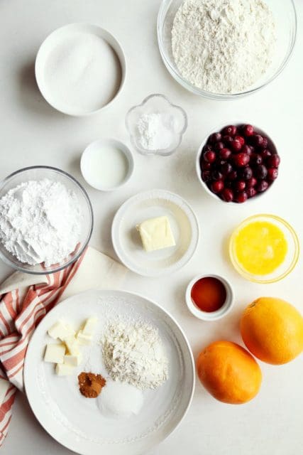 Ingredients for cranberry orange bread in small bowls.