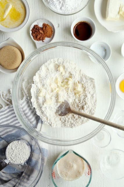 mixing butter into dry ingredients for cinnamon rolls.