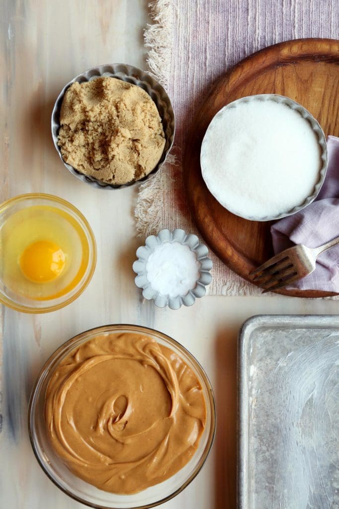 ingredients for peanut butter cookie recipe in small bowls.