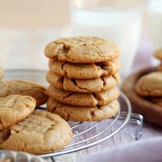 Crisp, salty, sweet peanut butter cookie recipe stacked on rack,
