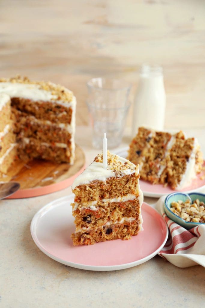 Huge slice of carrot cake on a plate.