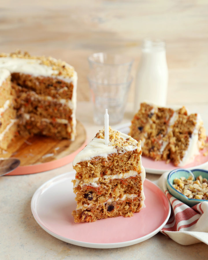 Huge slice of carrot cake on a plate.