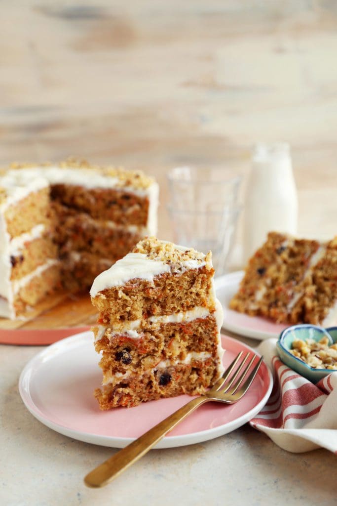 Two slices of perfect carrot cake on plates.