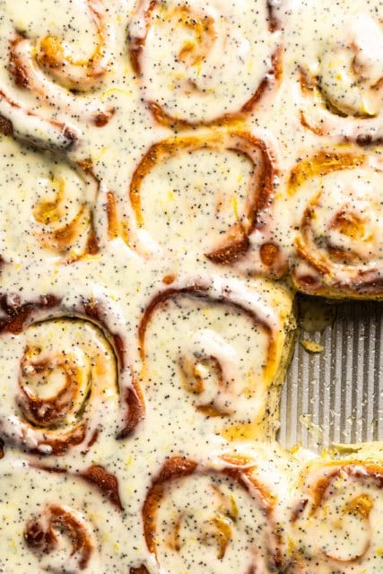 Close up of lemon poppy seed rolls in the baking pan.