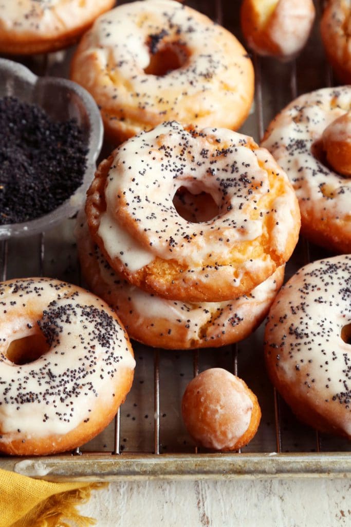 Two glazed doughnuts piled together.