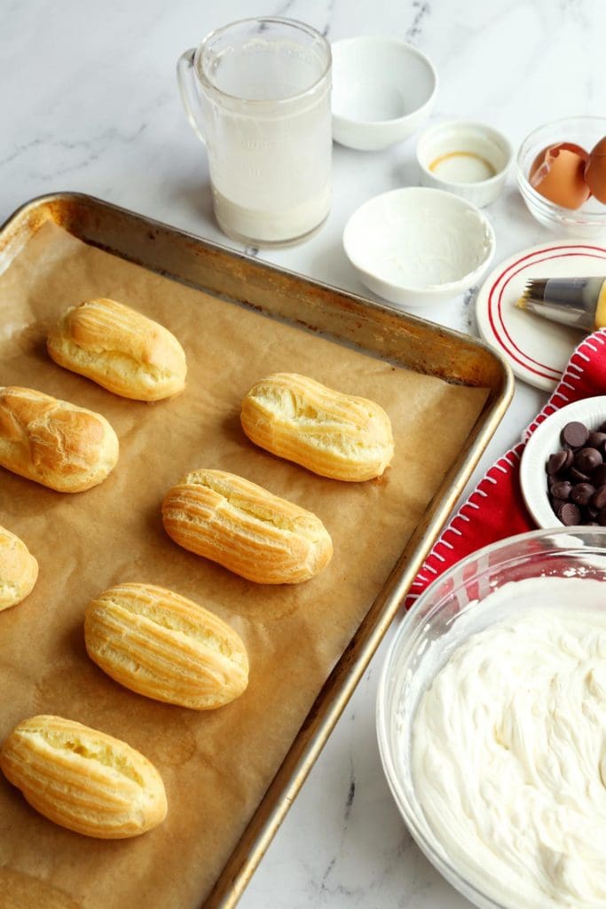 Baked eclair recipe out of the oven on a sheet tray.