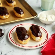 Two small eclairs on a plate.