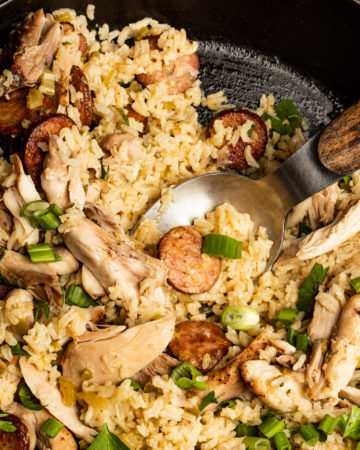 Serving finished jambalaya recipe into bowls.