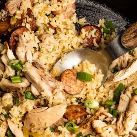 Serving finished jambalaya recipe into bowls.