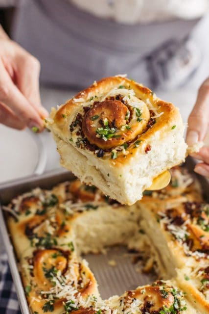 Baked sausage rolls being served my a serving knife.