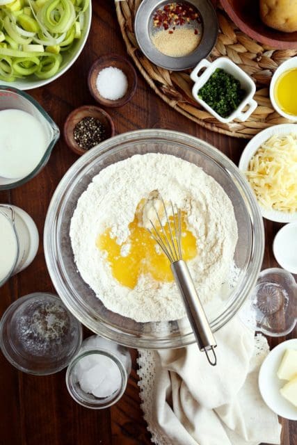 Flour, water, and melted butter in a medium bowl for pie crust.