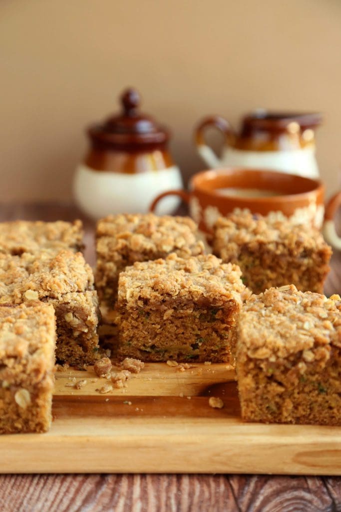 Coffee cake recipe cut into squares on a wooden board.