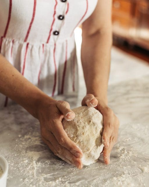 shaping no-knead rye bread into a ball.