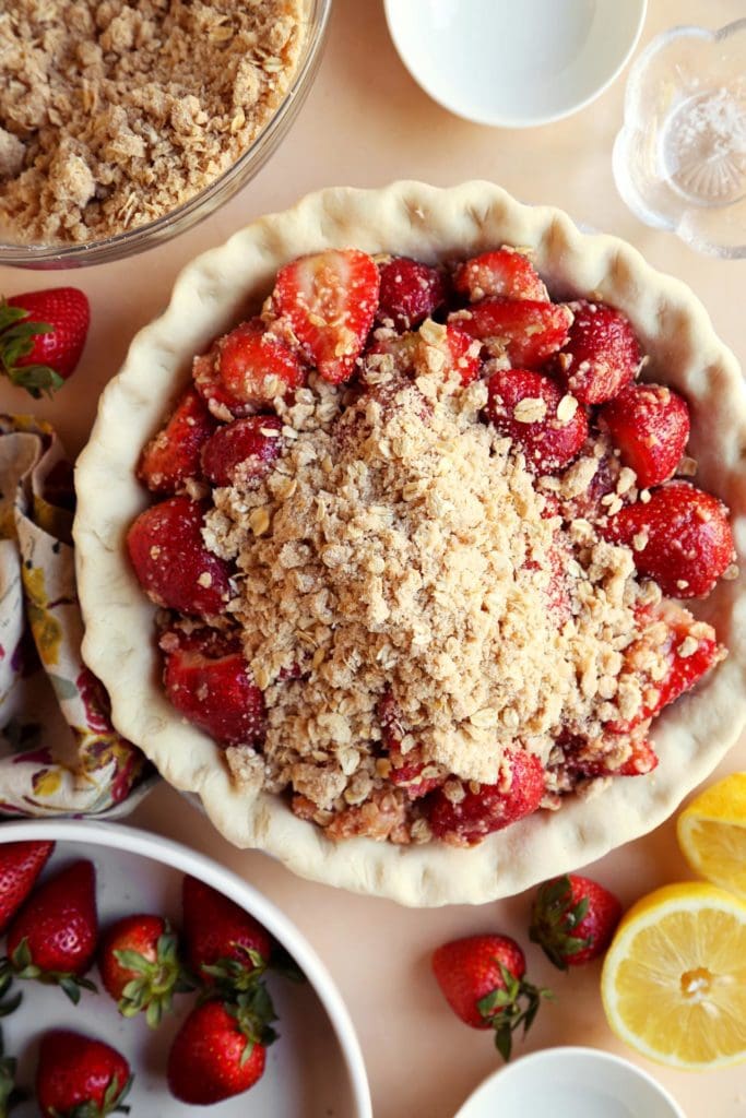 Strawberry pie filling inside of unbaked crust with crumble top.