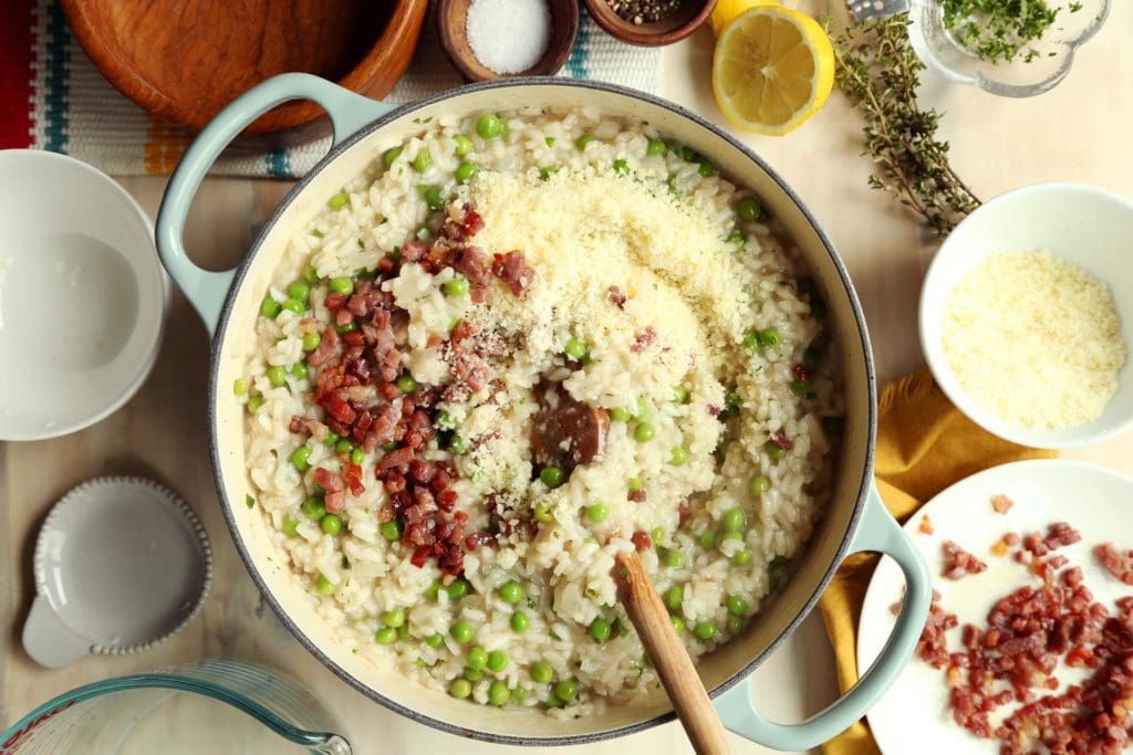 Adding pancetta to cooked risotto.