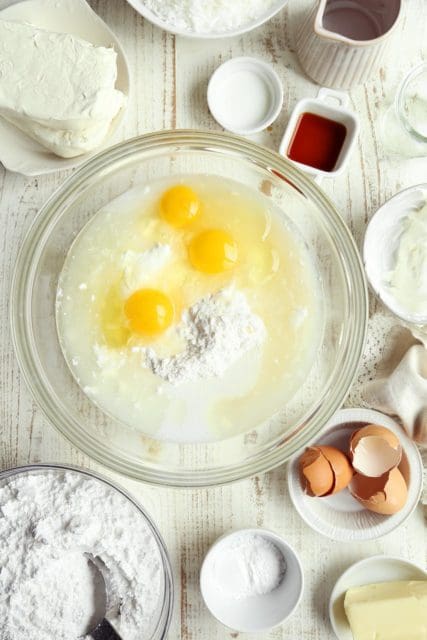 Cake mix with eggs and other cake ingredients in a large bowl.