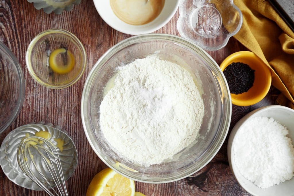 Adding dry ingredients to muffin recipe.