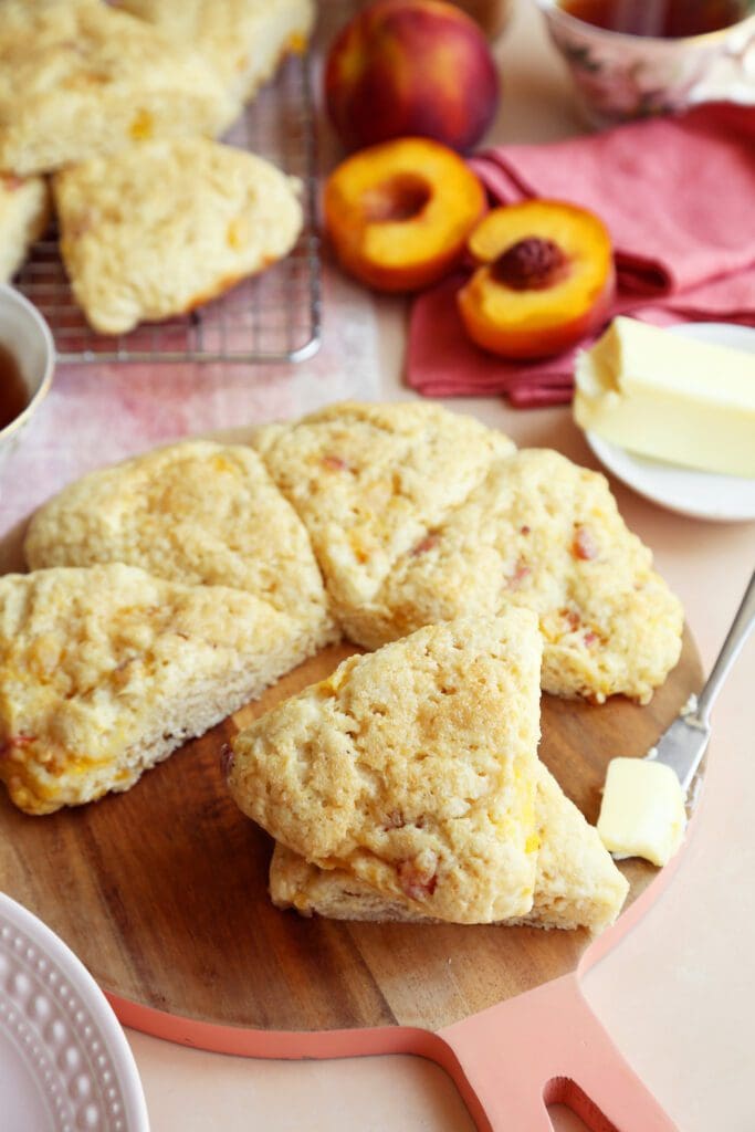 Baked peach scones stacked with a butterknife