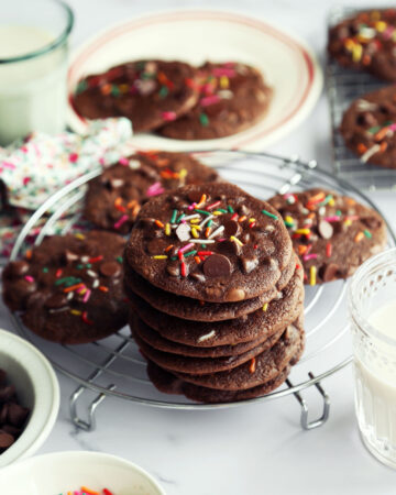 Stack of chocolate brownie cookies with sprinkles.