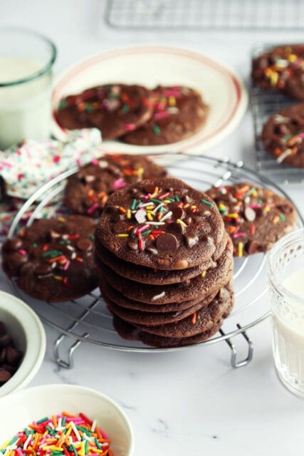 Stack of chocolate brownie cookies with sprinkles.