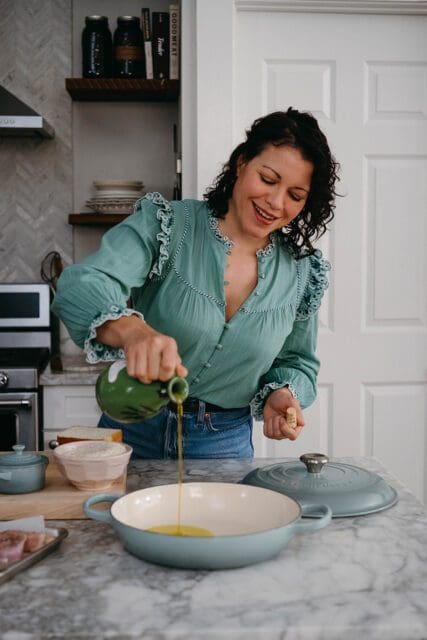 Pouring olive oil in a pan.