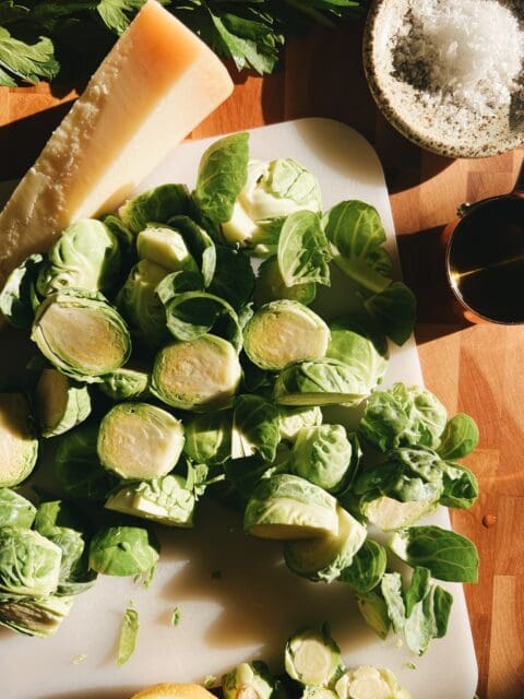 brussels sprouts sliced in half on cutting board