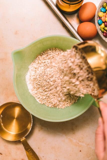 Oatmeal being poured into a bowl.