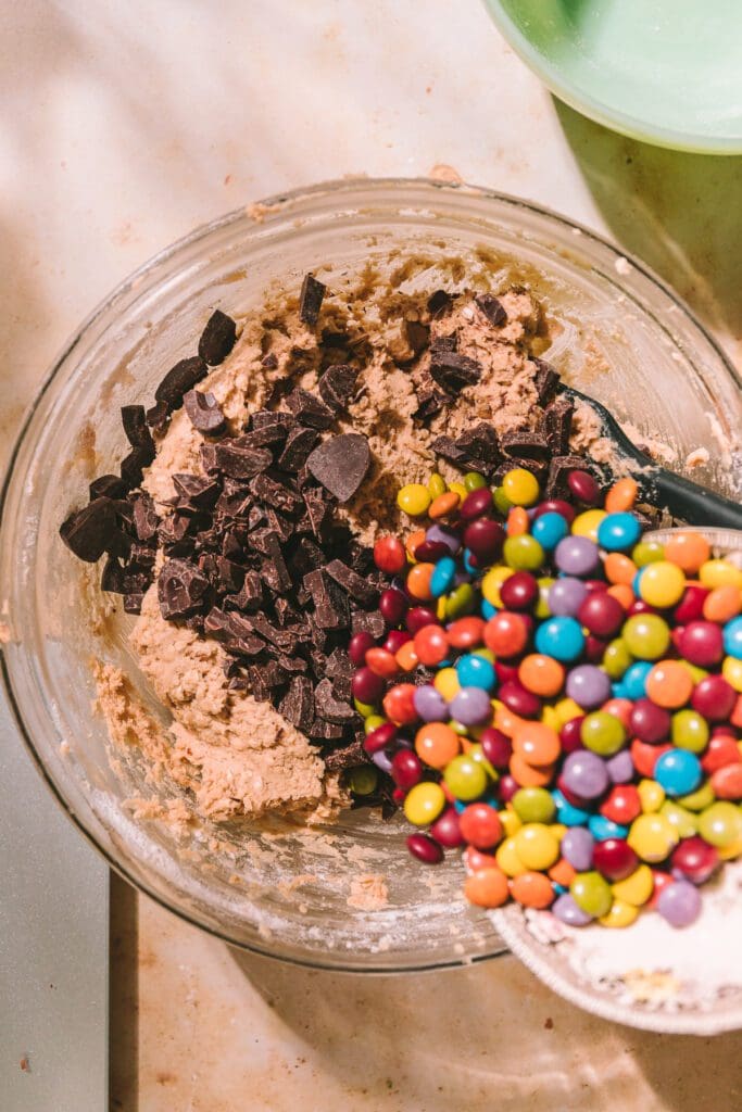 Adding chocolate candy pieces to cookie dough