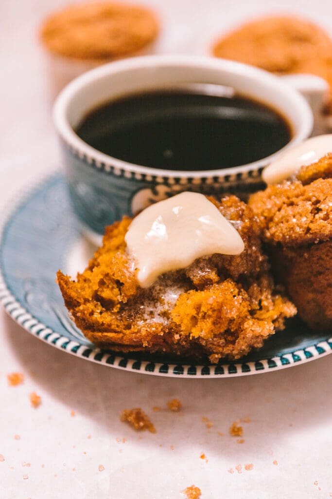 melted pumpkin muffins on a plate with coffee