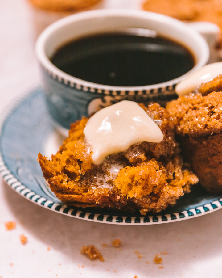 melted pumpkin muffins on a plate with coffee