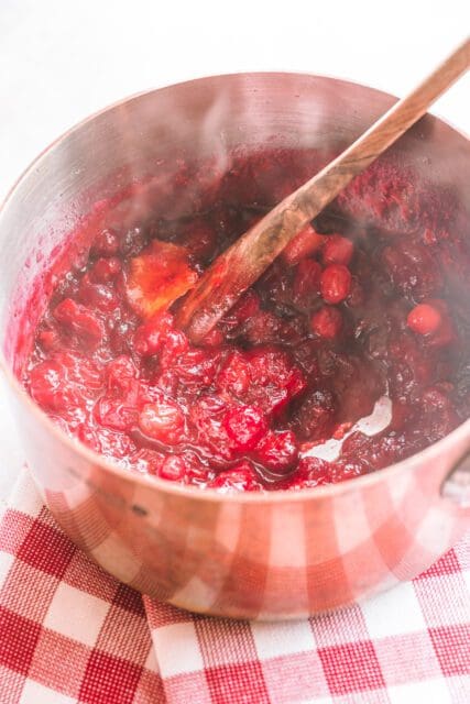 Fresh cranberry sauce cooked in a small saucepan