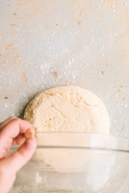 Drumping risen dough onto floured counter